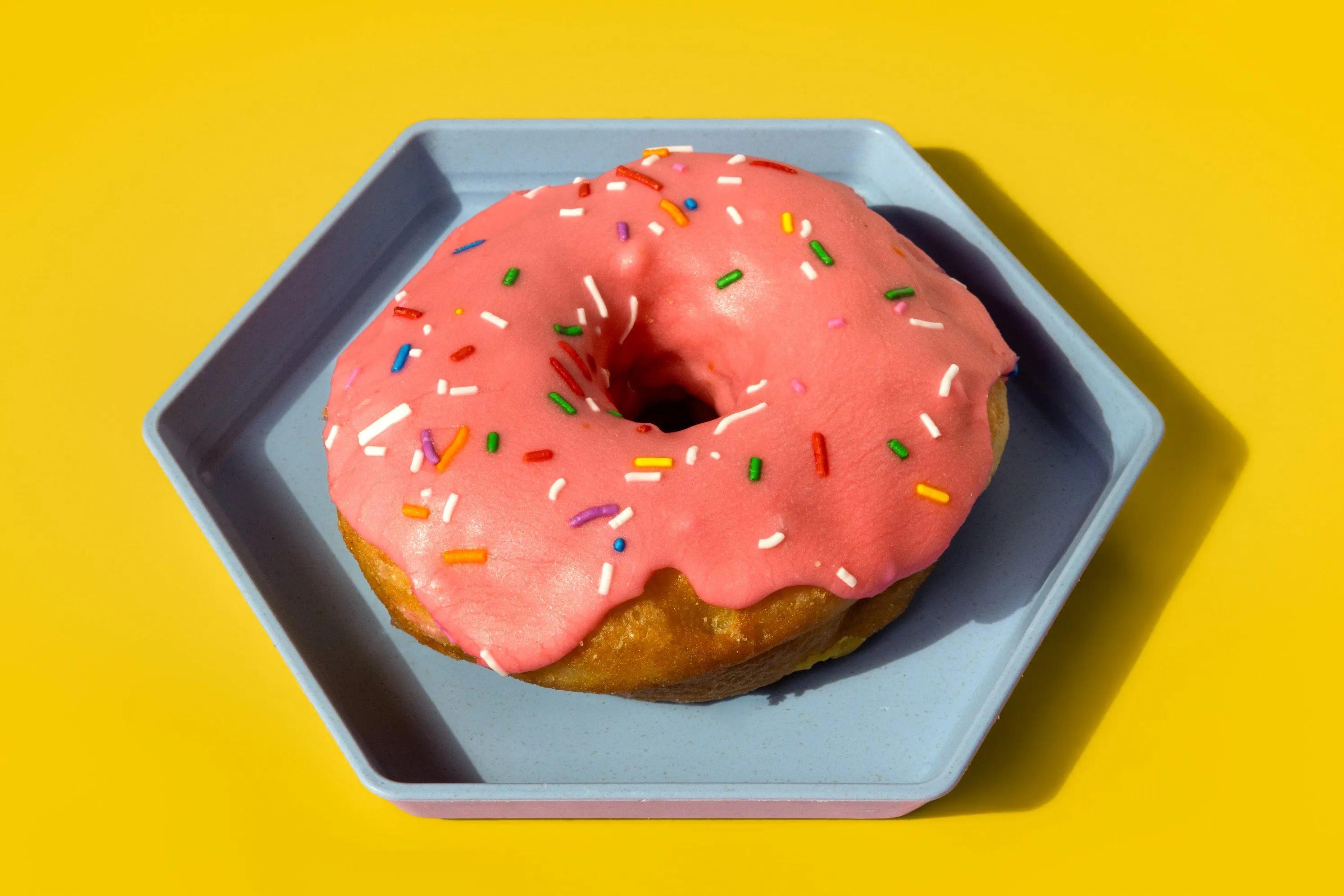 A pink-glazed donut from The Hive Donut Hut.