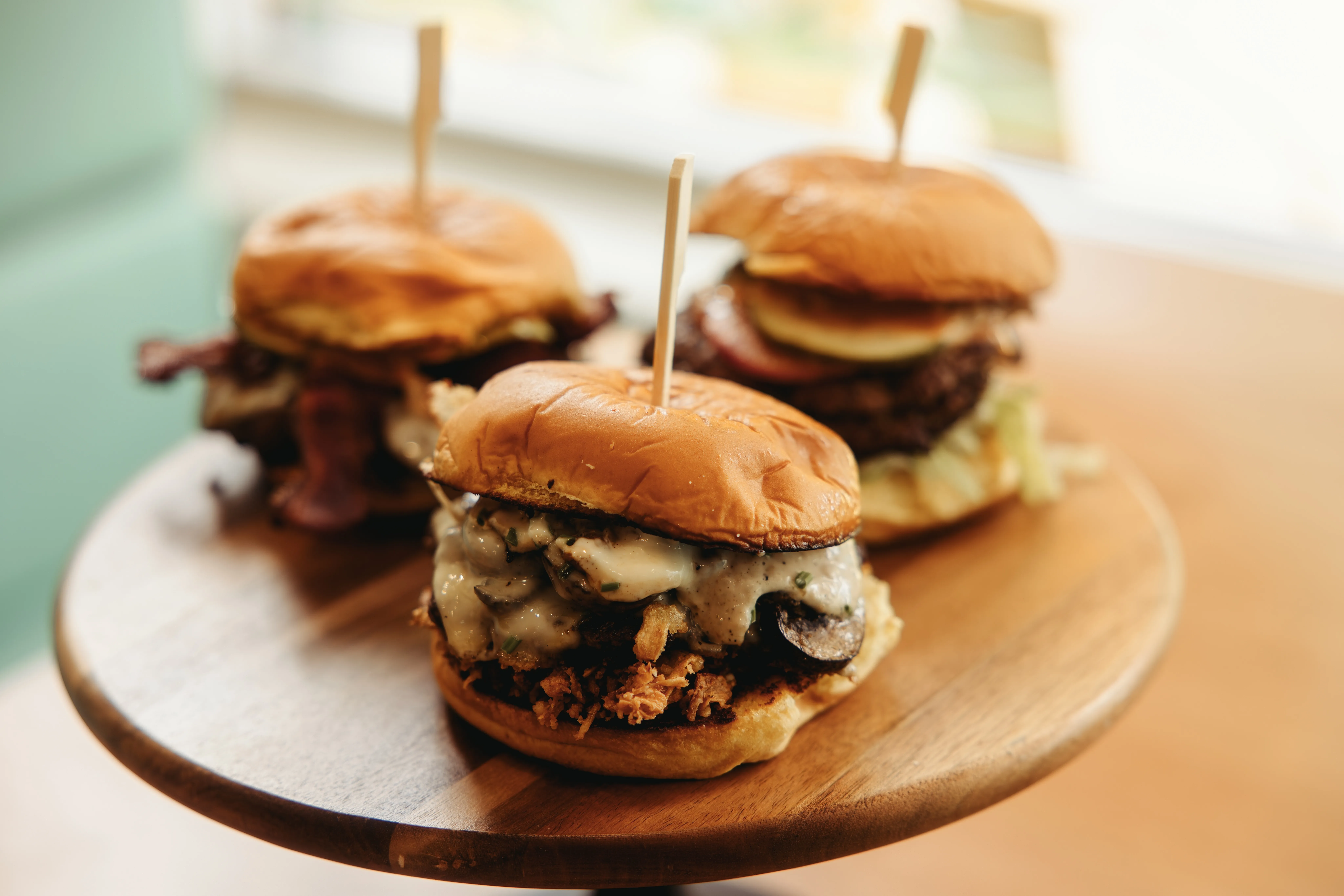 A trio of smashburgers on a platter.